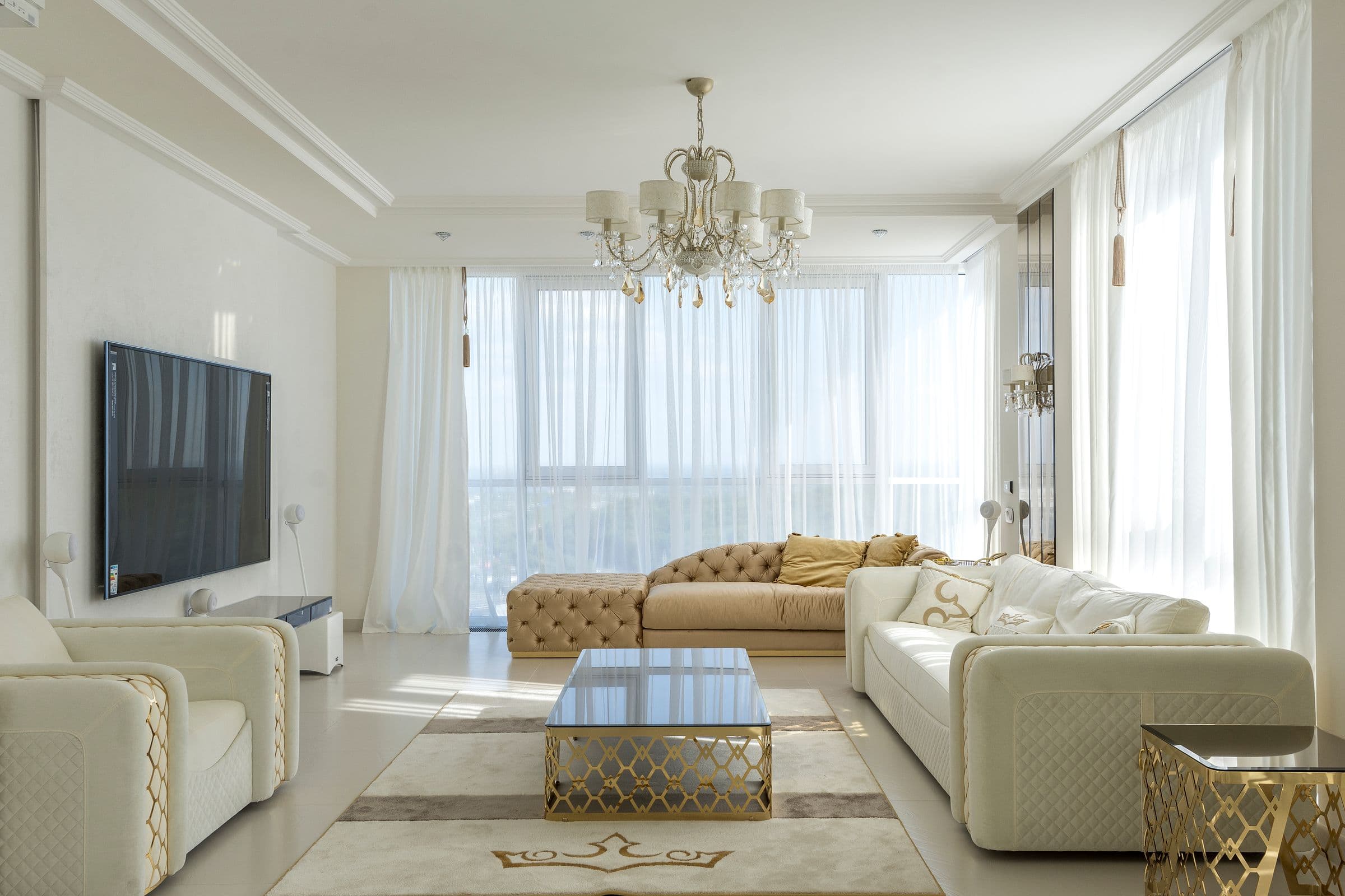A bright, spacious apartment living room with floor to ceiling windows